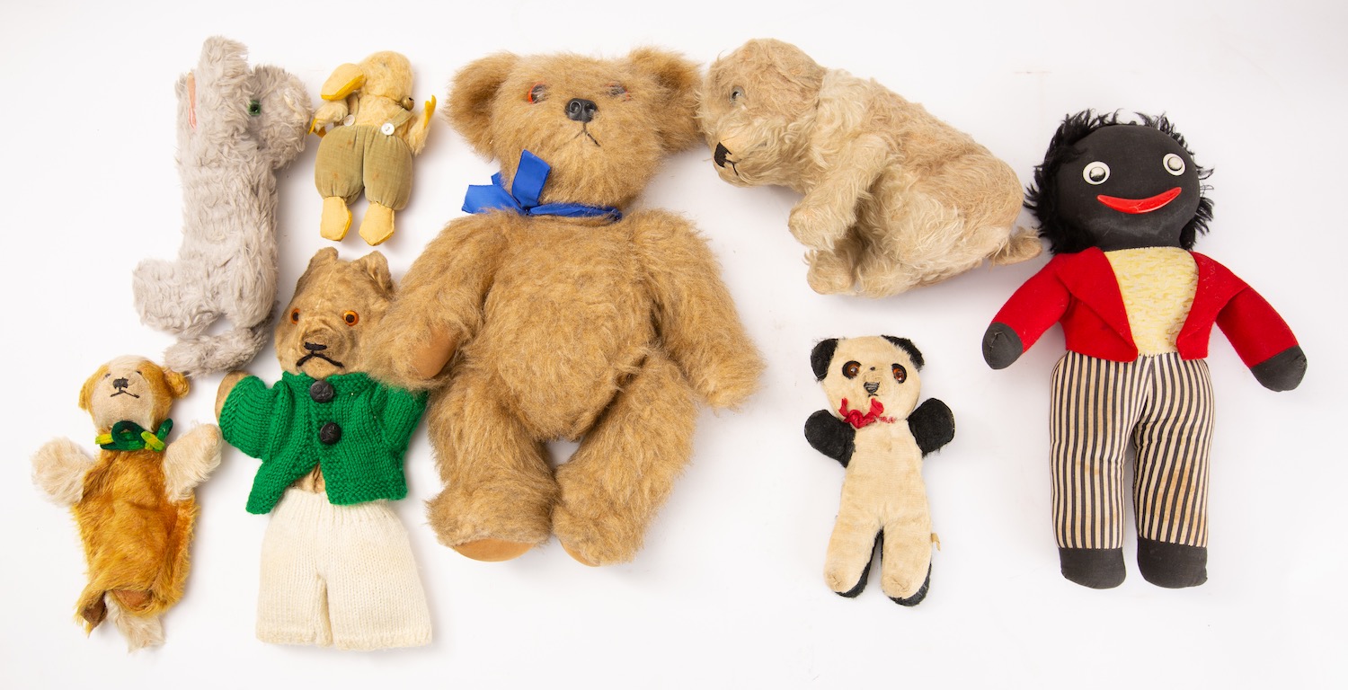 Two blonde plush Teddy bears, together with a collection of various other figures.