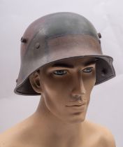 A WWI period German M1916 Stahlhelm, hand painted camouflage finish with brown leather liner,