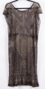 An early 20th-century Egyptian Assuit silver and black cotton dress, central lozenge pattern,