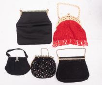 Two mid 20th century beadwork evening bags, together with three later evening bags.