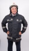A collection of various fire fighting uniform, comprising two Cromwell F600 helmets,