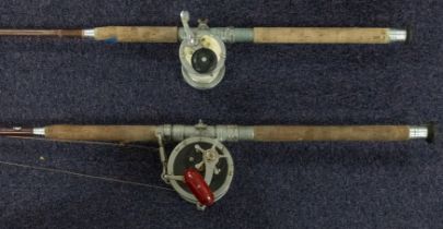 Two hollow glass rods, one with a Penn Senator 9/0 reel,