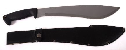 A 20th century Bolo Machete, with one piece moulded resin grip, in a black leather scabbard,