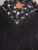 A Victorian black silk shawl, with floral embroidered decoration and tassel fringe,