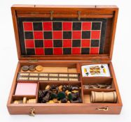 A mahogany cased game compendium, comprising boxwood Staunton pattern chess set, cards, draughts,