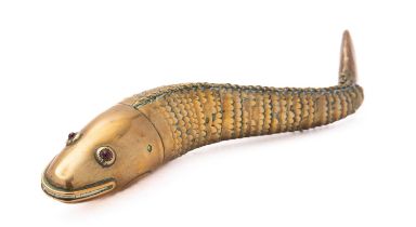 An early 20th century articulated brass fish with red glass eyes, 23.5cm long.