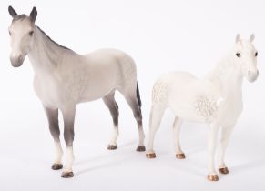 Two dapple grey Beswick horses, in matte and gloss finish, the largest 20cm high overall.
