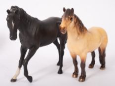 A Beswick black matt glazed horse and a Bewsick Highland horse,