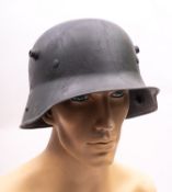 A WWI period German M1916 Stahlhelm, hand painted camouflage finish with white leather liner,