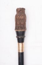 An early 20th century walking cane with carved owl handle,