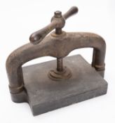 An early 20th century cast iron book press, 42cm wide.