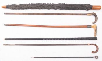 A group of five various walking sticks, comprising an antler handled stick, two horn handled sticks,