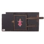 Girl in red dress skipping, an early 'Desh' type with double brass lever,8 1/2 x 4 1/2 inches