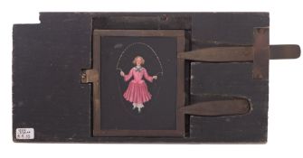 Girl in red dress skipping, an early 'Desh' type with double brass lever,8 1/2 x 4 1/2 inches