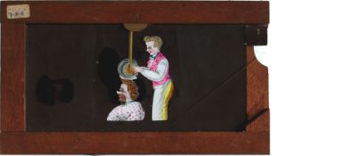 Slide 419, 'Barber giving man mechanical haircut' Maker unknown (7 x 4 x 3/8 inches), single slip