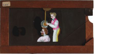 Slide 419, 'Barber giving man mechanical haircut' Maker unknown (7 x 4 x 3/8 inches), single slip