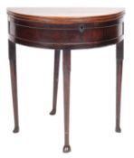 A mid 18th-century oak demi-lune table; with hinged top, above a box interior,