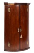 A George III mahogany bow fronted hangin