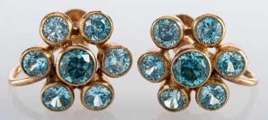A pair of 9ct gold blue zircon cluster earrings; each flowerhead cluster collet set with brilliant