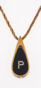 A pendant and chain; 9ct gold rope chain with unmarked yellow metal pendant, the interior with resin