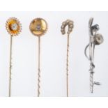 Three stick pins, one horseshoe and pearl, another with small diamond, one marked 15ct,