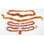 An amber necklace, composed of graduated amber beads, 52cm long; and three further amber necklace.