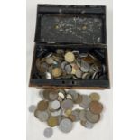 A vintage cash tin containing a collection of British and foreign coins. Includes examples from