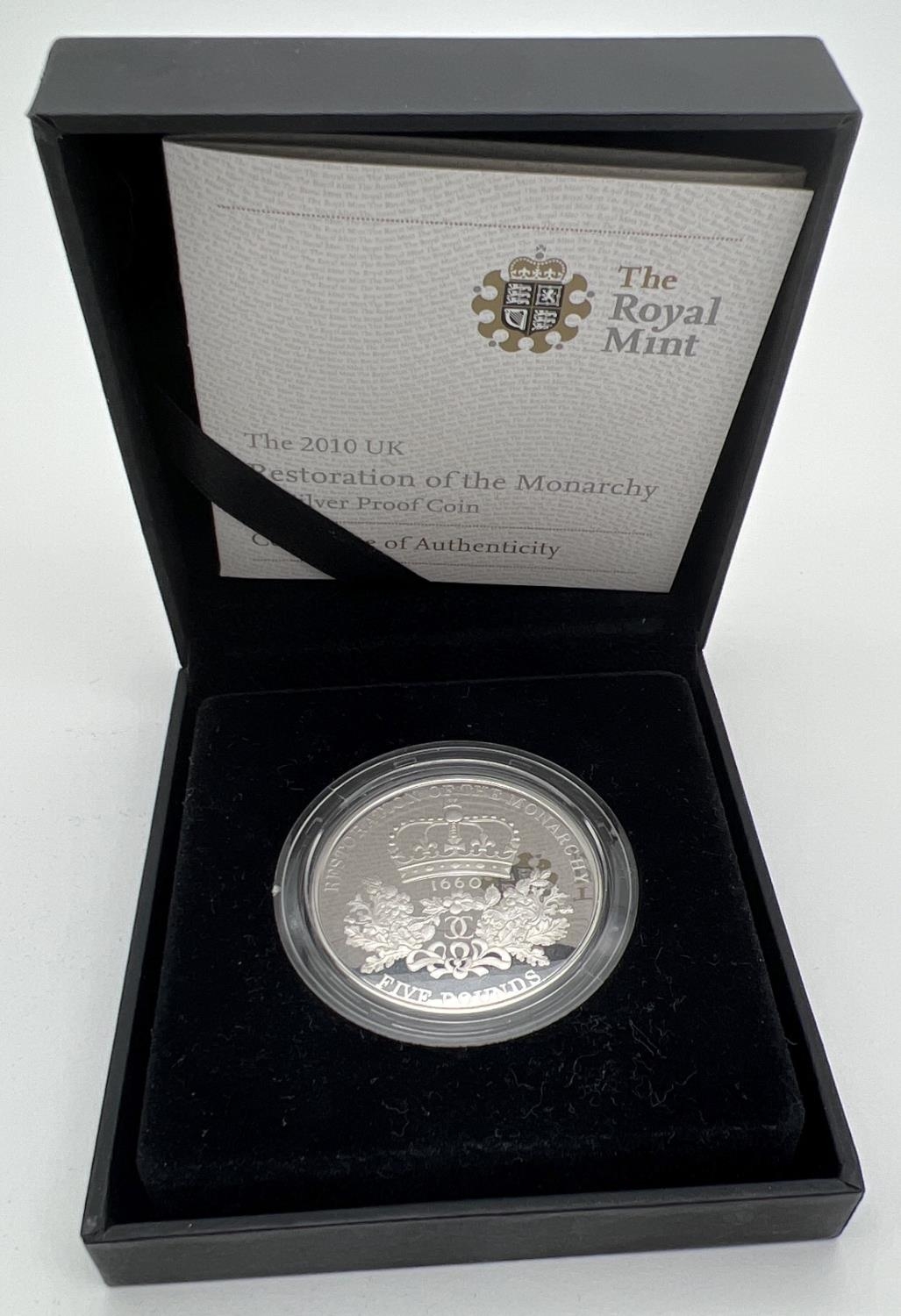 A boxed limited edition 2010 Restoration of the Monarchy Â£5 silver proof coin by The Royal Mint.