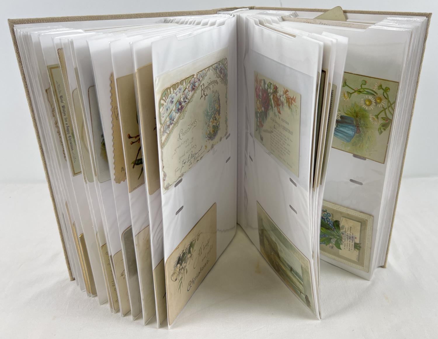 A large album containing 163 assorted Victorian and Edwardian greetings cards. In varying shapes,