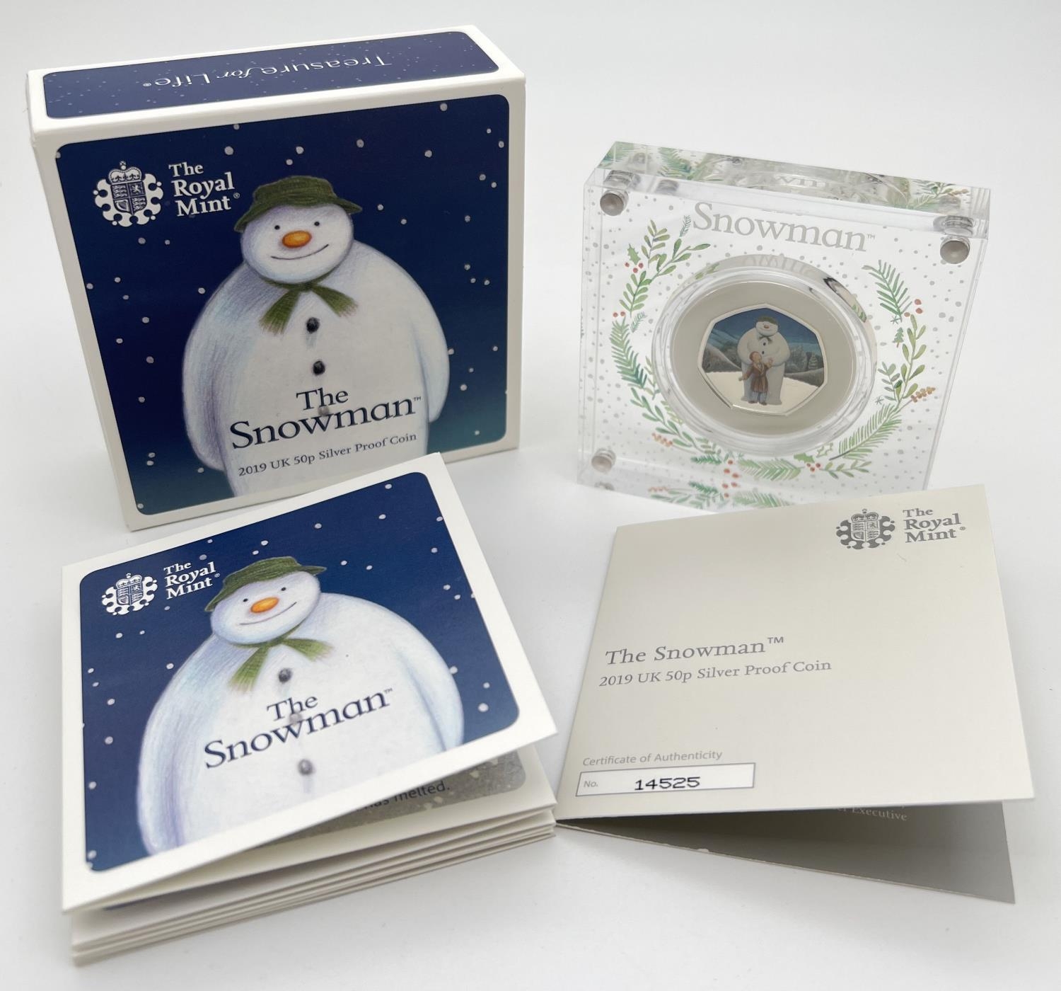 A 2019 limited edition "The Snowman" colourised silver proof 50p coin by The Royal Mint. Held within