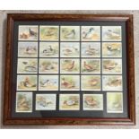 A framed and glazed set of 25 reproduction Player's Game Bird & Wild Fowl cigarette cards. 1987