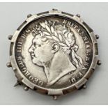 A George IIII silver half crown, dated 1820, in a Victorian silver brooch mount. Crown shield of