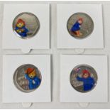 A set of 4 Paddington Bear 50p coins with coloured decals. Comprising: 2018 Paddington at the