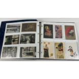 A large blue postcard album containing 220 assorted Edwardian & vintage postcards. To include: