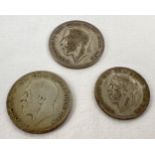 3 George V half silver coins. A 1924 half crown, 1928 half crown and a 1931 florin.