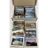 A box of 750 assorted vintage & more modern colour postcards. To include British and overseas cards.