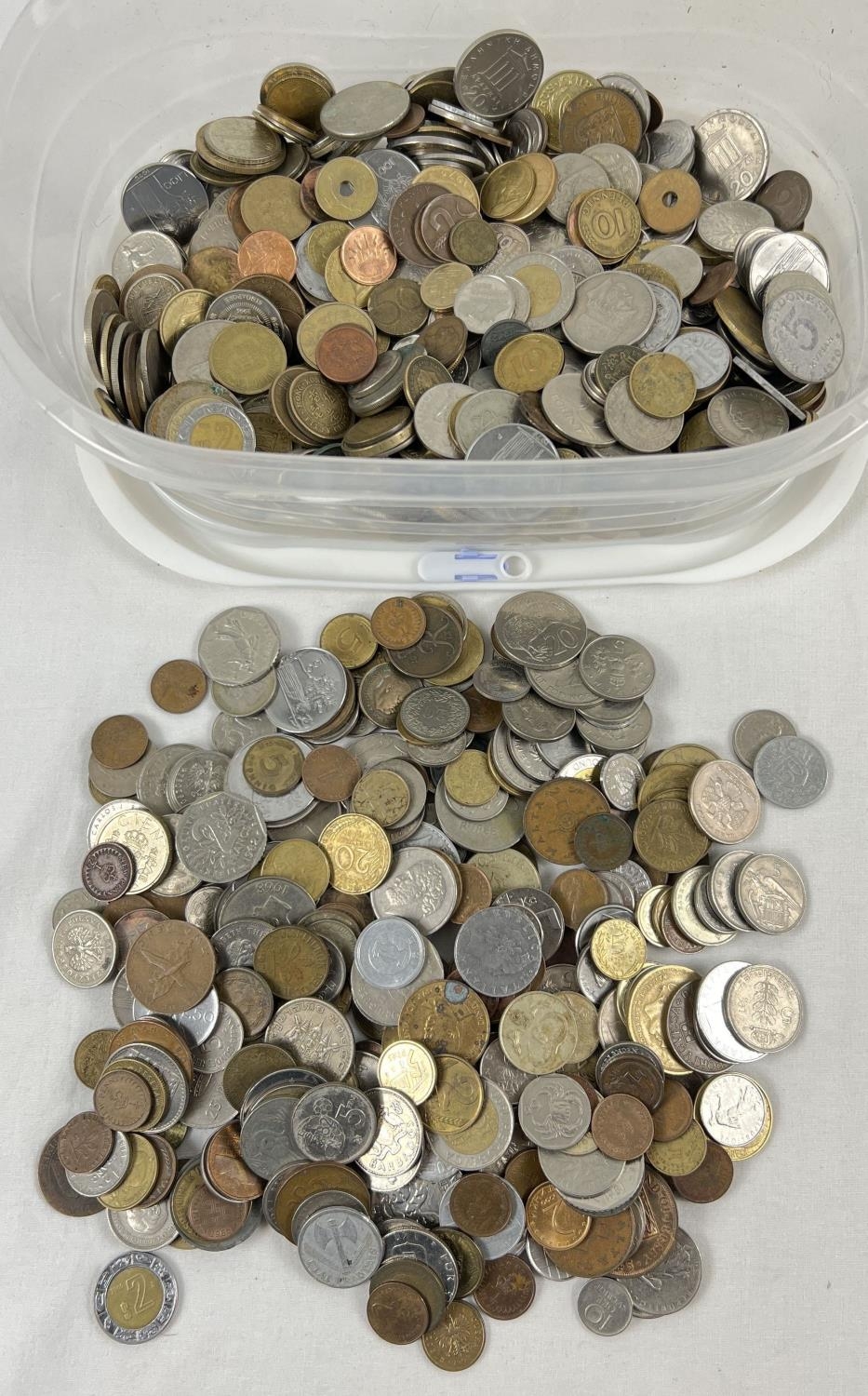 A tub of vintage British and foreign coins. To include examples from France, Malta, Austria,