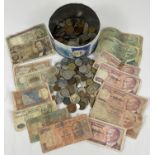 A vintage tin of assorted foreign coins and bank notes. To include examples from India, Turkey,