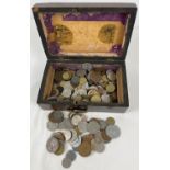 A vintage wooden box containing a collection of British and foreign coins. To include examples
