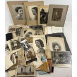 A box of assorted vintage photographs, portraits, cabinet cards and photographic negatives. Mostly
