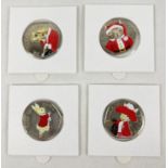 A set of 4 Beatrix Potter 2017 50p coins with coloured Christmas decals. In sealed card & clear