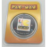 A sealed 2 dollar colourised Pac-Man . 999 silver coin from the Island of Niue. In original
