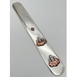 A vintage Tiffany & Co silver and mixed metal letter opener with embossed floral design to front.