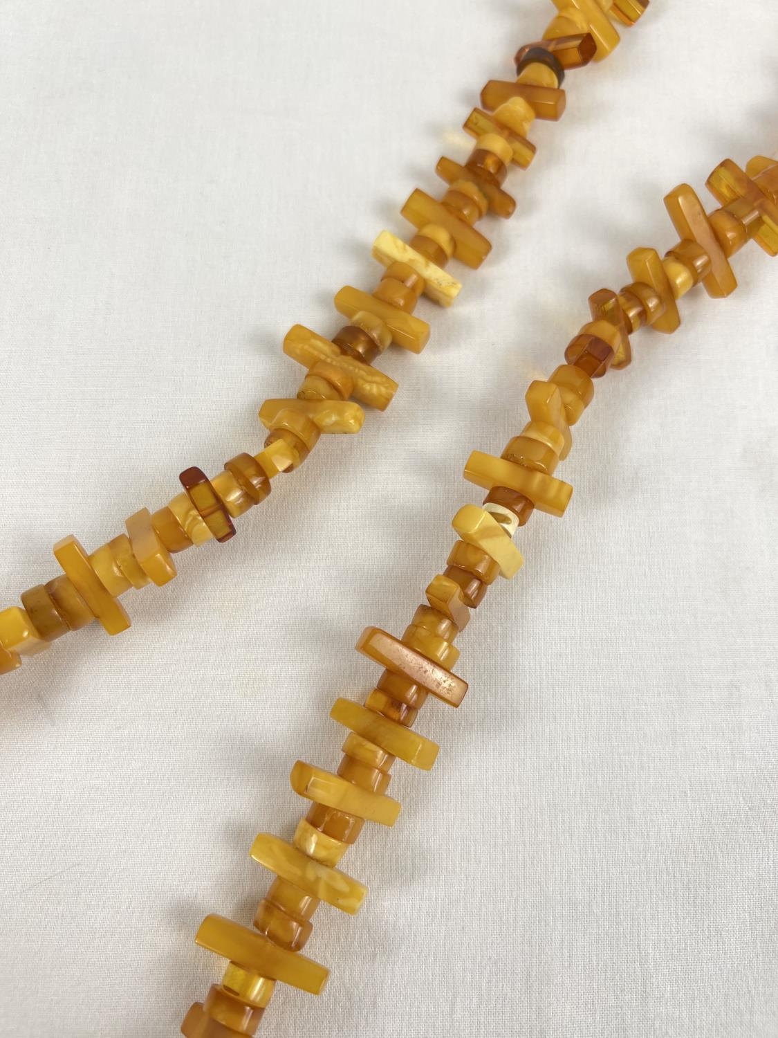 A 48" honey and butterscotch amber rectangular and circular bead necklace. Total weight approx. - Image 2 of 2