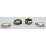 4 silver Celtic design band style rings. One set with a single round cut blue topaz and another