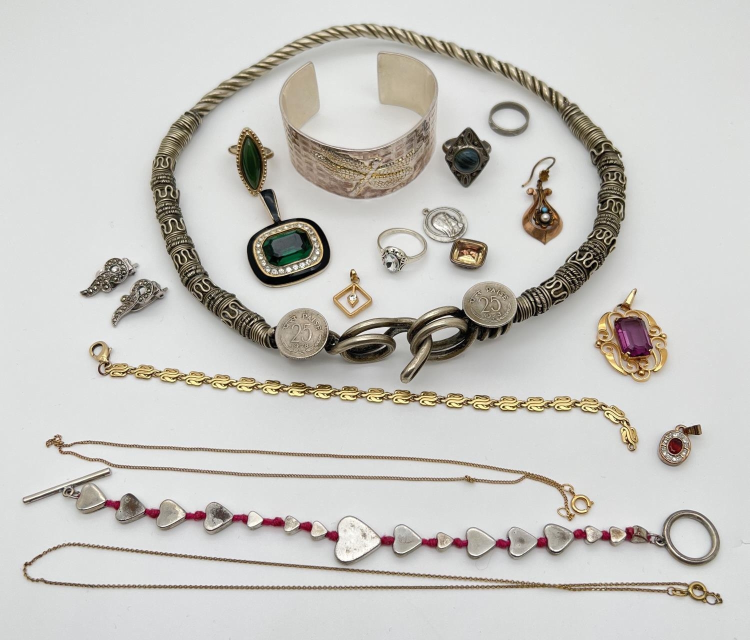 A small collection of costume jewellery. To include a large ethnic design torque style necklace, a