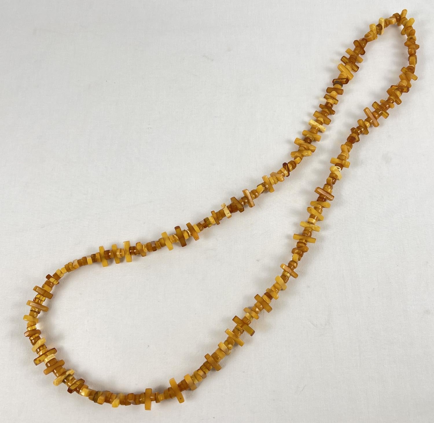 A 48" honey and butterscotch amber rectangular and circular bead necklace. Total weight approx.