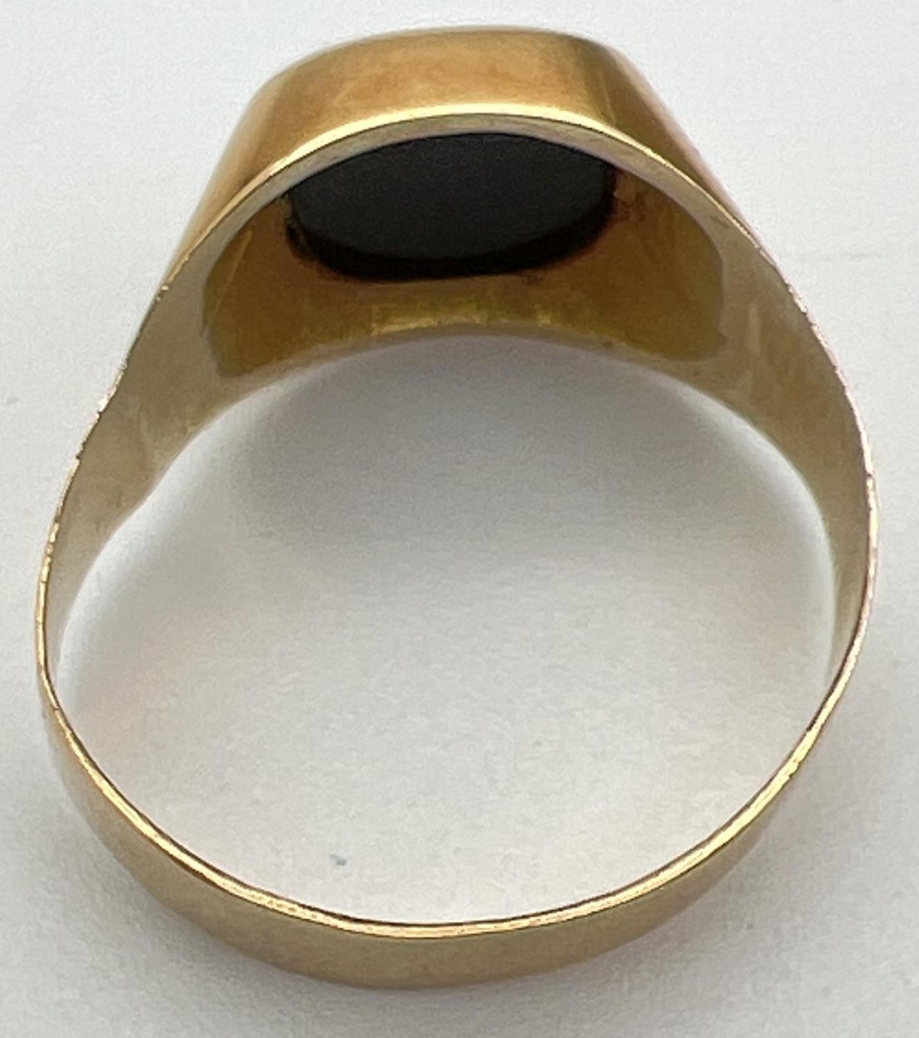 A men's 20ct gold and black onyx signet ring, band slightly misshapen. Stamped 83.5 inside band. - Image 4 of 4