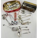 A collection of silver and silver plate cutlery, serving spoons and napkin rings. To include