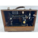 A c1950's 99K model Singer sewing machine with mock croc design wooden case. Complete with